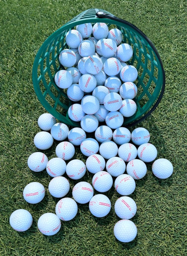 A green bucket filled with blue and white balls